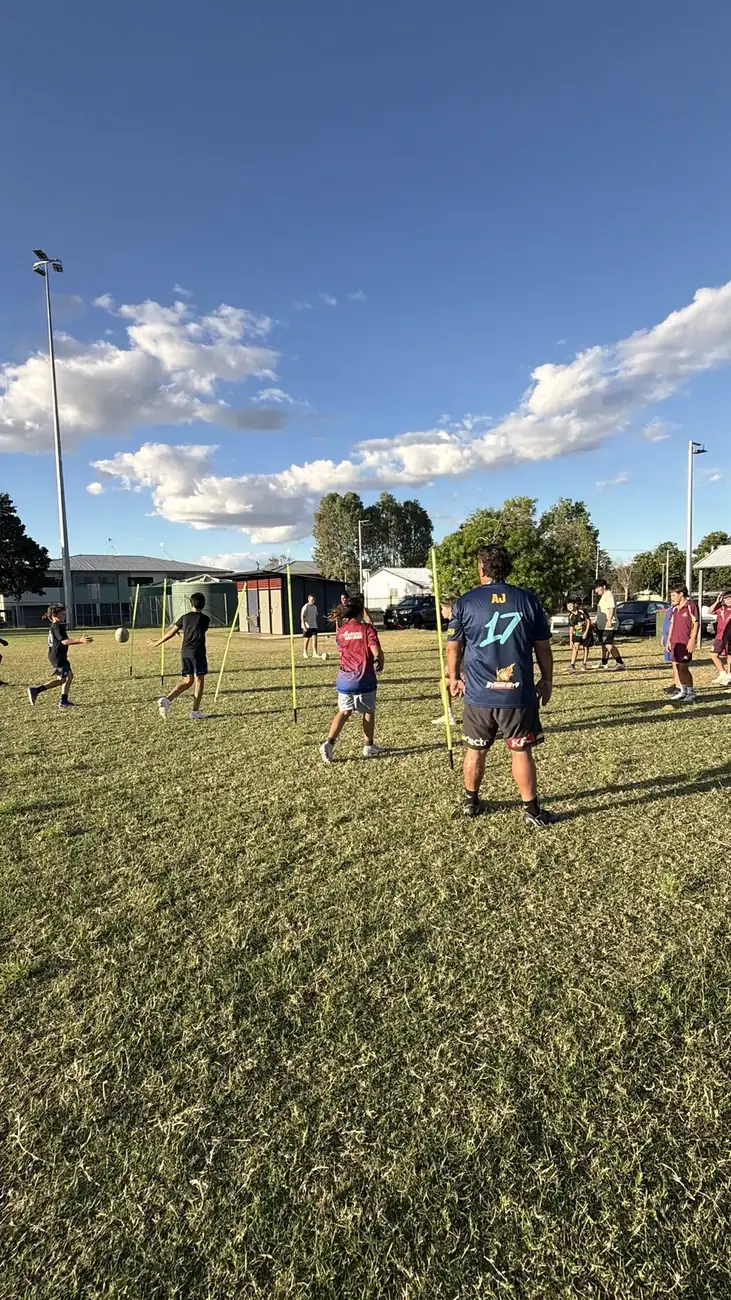 AJ coaching players through ball drills at training