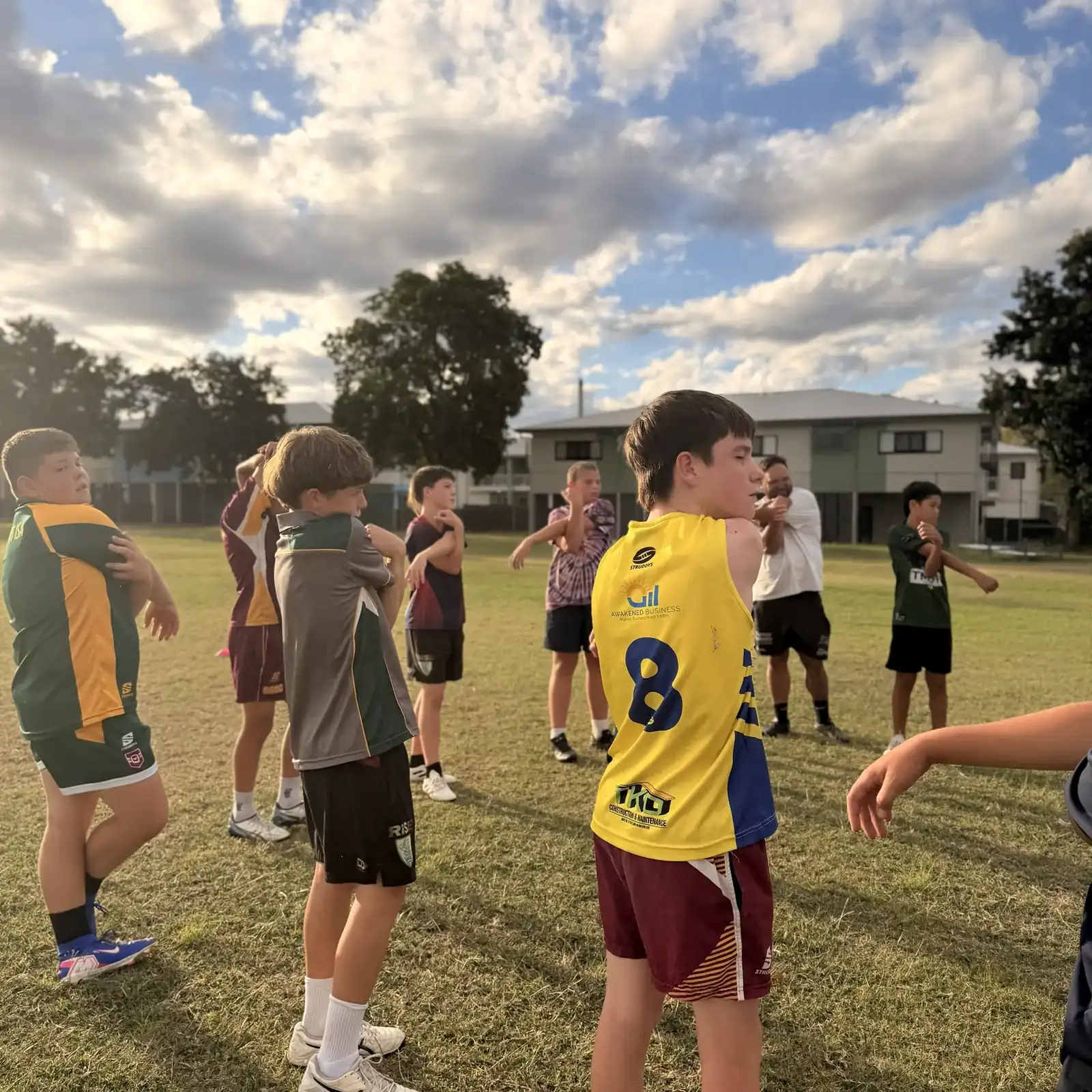 Young players stretching together at training