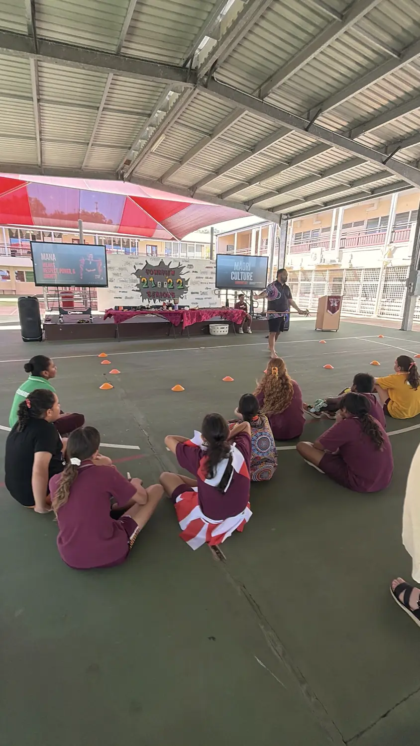 Students sitting on the court watching a Māori culture session at Townview State School