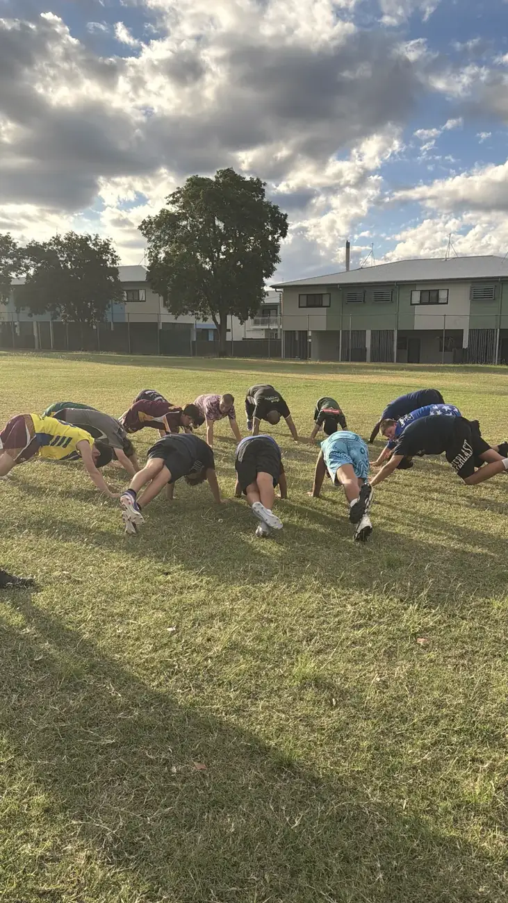 Players stretching in a circle at training